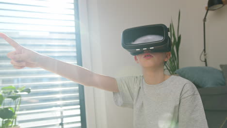 Boy-experiencing-virtual-world-by-using-virtual-reality-headset,-medium-shot